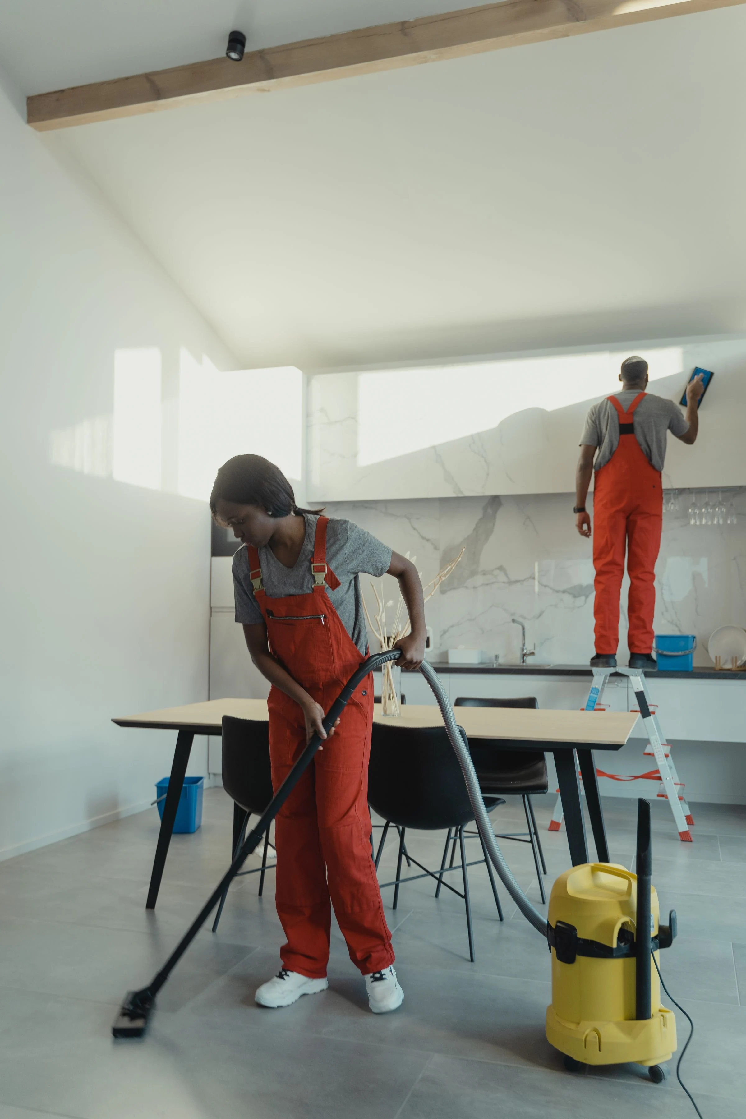 Cleaning staff sanitizing a kitchen