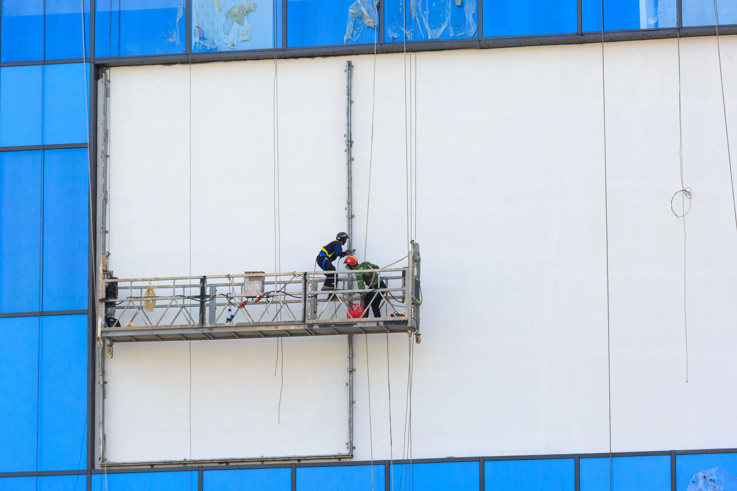 Crew maintaining a building facade